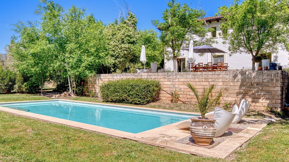 The garden and pool at Casa Son Cabaspre with the house behind