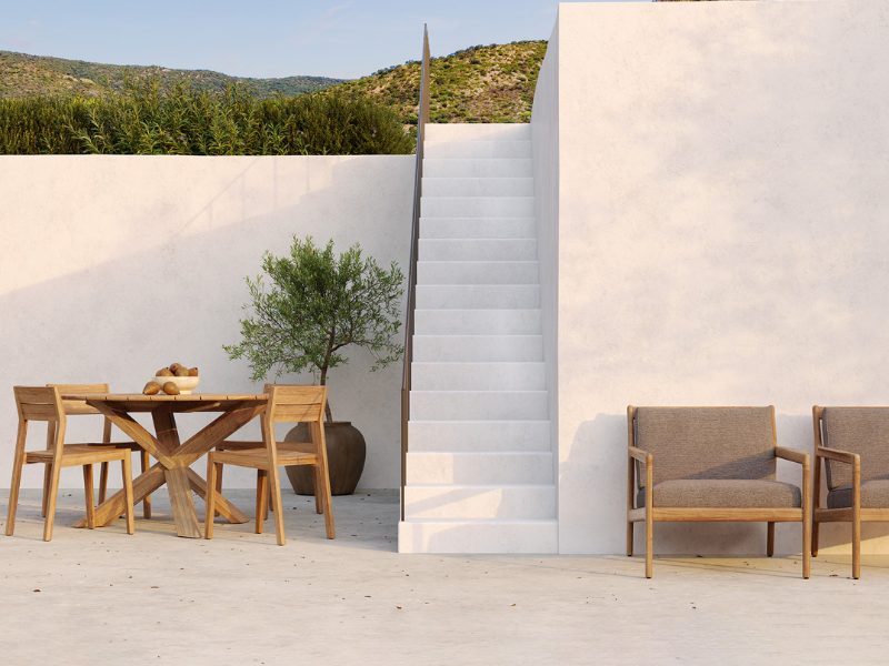 A table and chairs on a white terrace