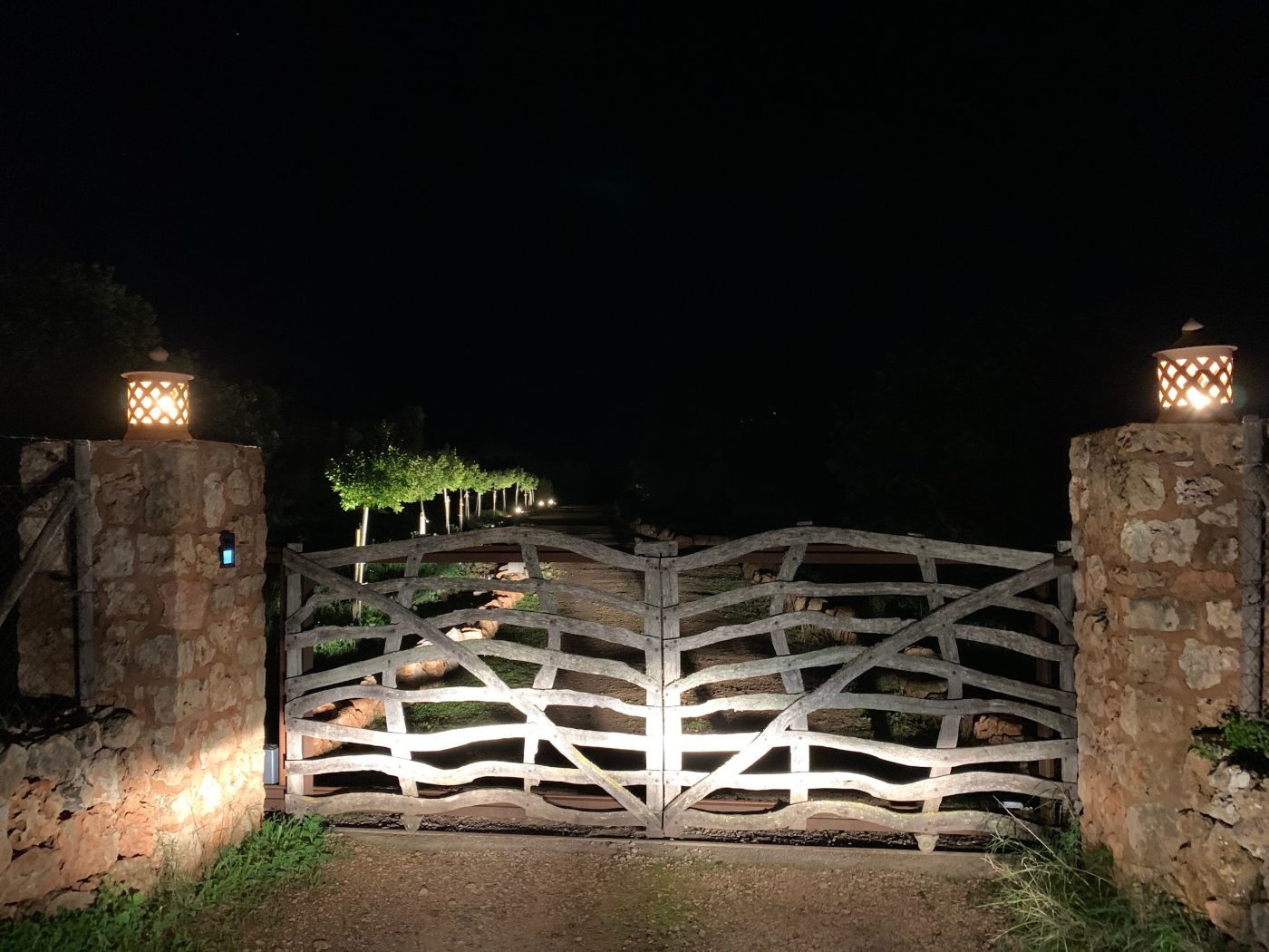 The gate at Los Hibiscus, lit at night