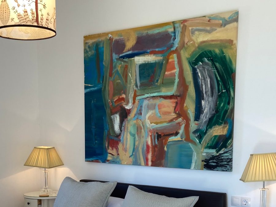 A bedroom at Los Hibiscus with a large painting above the bed