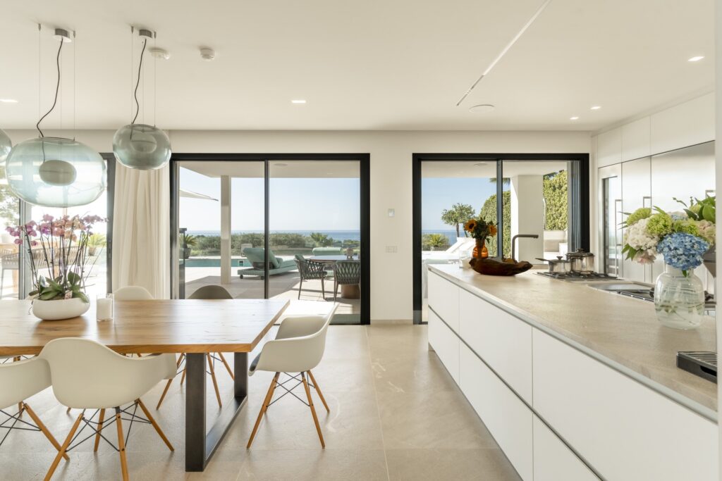 Kitchen and dining area opening to the terrace and the sea